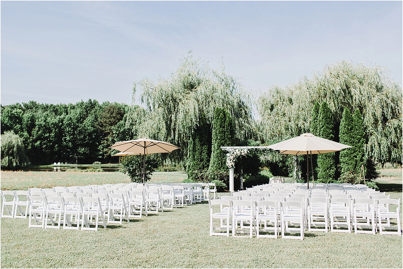 Ceremony Seating with White Chairs + Umbrellas 